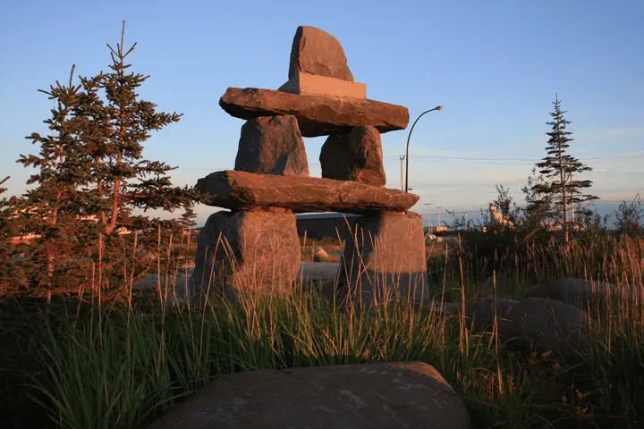 Inuksuk stone sculpture in a northern landscape